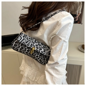 Detail of vintage leopard print shoulder bag with gold metal U-shaped buckle closure