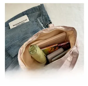 Detail view of large capacity floral tote bag showing interior storage for daily items