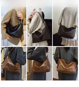 Three colors of oversized matte hobo bags shown on model with adjustable gold buckles