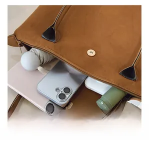 Interior view showing large capacity and magnetic closure of the brown tote bag