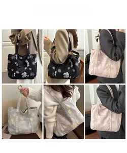 Detail view of large floral canvas tote bags showing multiple patterns and strap design