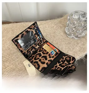 Close-up of leopard print wallet interior showing multiple card slots and clear ID window