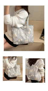 Detail of floral canvas tote bag showing soft fabric texture and long shoulder straps