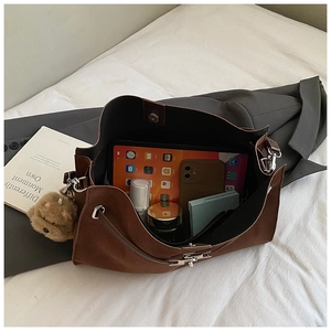Detail view of large brown suede tote bag with storage space for iPad and essentials