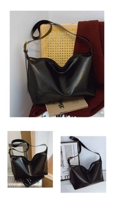 Detail of black PU leather shoulder bag with smooth texture and golden metal buckle