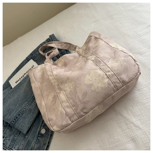 Detail of floral canvas tote bag in lavender featuring large flower prints on bed linen