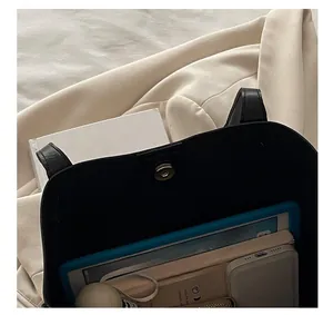 Detail show of large black leather tote bag with magnetic closure and inner storage