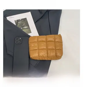 Quilted nylon storage pouch size comparison with a smartphone on a flat lay background