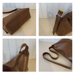 Detailed views of dark brown faux leather bag with gold buckle and smooth zipper closure