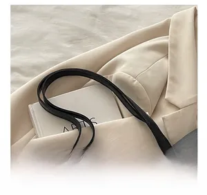 Close-up of durable black faux leather shoulder strap stitching on large tote bag