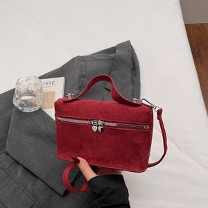 Minimalist burgundy suede box handbag with heart zipper pulls and long shoulder strap