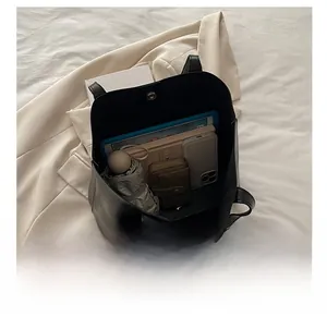 Interior view of large black leather tote bag showing capacity for tablet and daily items