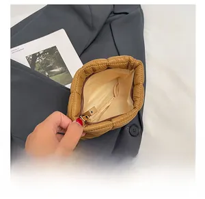 Detail view of the spacious inner compartment and smooth zipper of the brown quilted bag