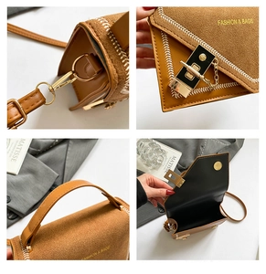 Detail view of brown suede bag showing golden lock, stitching, and hardware components
