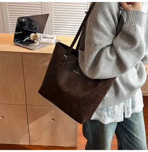 Detail of dark brown matte tote bag with adjustable strap and JuHai brand logo