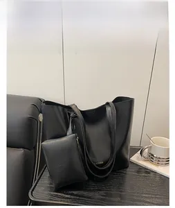 Detailed view of black large-capacity tote bag with matching zipper coin purse and gold logo
