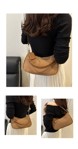 Detail of brown woven underarm bag with gold chain strap and elegant leather trim