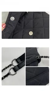 Detail view of black quilted oxford bag with magnetic snap and chain shoulder strap