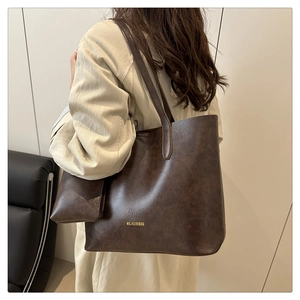 Detail shot of the vintage dark brown tote bag with an inner pouch and branded logo
