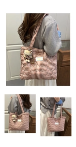 Quilted tote bag with brown checkered pattern and plush cat pendant charm