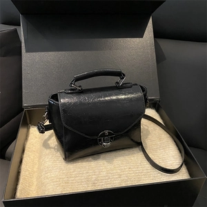 Minimalist black oil wax leather square handbag with metal clasp and leather strap