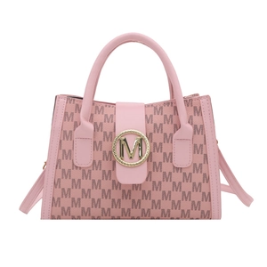 Pink crossbody bag with M monogram print and golden circular metal clasp in studio shot