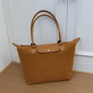 Classic tan large capacity tote bag with gold hardware and top handle for women