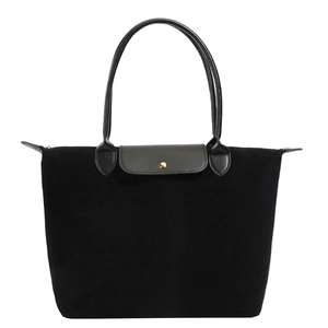 Minimalist black tote bag with matte leather flap and suede texture finish in 2025 style