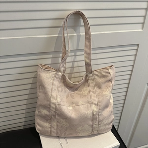 Large capacity canvas tote bag with white floral print and a front pocket
