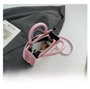 Top view of pink crossbody bag showing spacious interior with woven handle detail