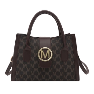 Brown monogram shoulder bag with gold metal M buckle in a stylish minimalist design
