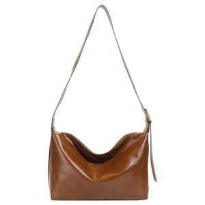 Minimalist vintage brown shoulder bag with polished texture and adjustable strap in front view
