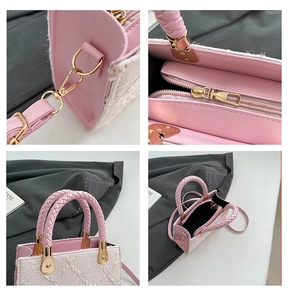 Detail of tweed crossbody bag featuring pink leather handles and gold metal hardware