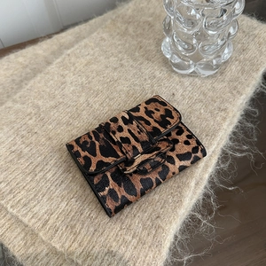Mini leopard print card holder wallet for women on soft knit texture background
