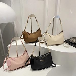 Minimalist woven half-moon shoulder bags in brown, beige, pink, and black with gold chains