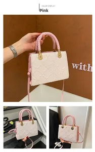 Detailed view of white jacquard handbag with pink braided handle and gold hardware links