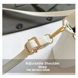 Close-up of white pebble leather bucket bag with adjustable strap and gold metal buckle