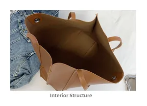 Internal structure of large brown leather tote bag showing spacious space and metal snaps