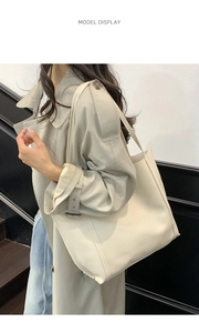 Dettaglio di una borsa tote in pelle beige crema su modella con stile urbano chic