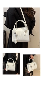 Detailed macro view of white faux snakeskin texture and fashion embossed logo on the bag