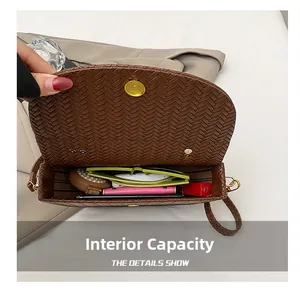 Macro detail of the woven leather bag interior showing capacity for daily essentials