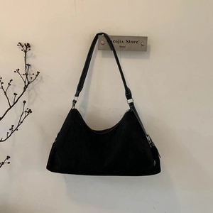Minimalist black faux suede underarm bag with silver buckle and sleek shoulder strap
