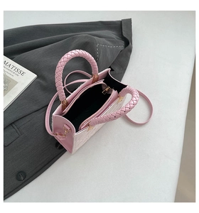 Detail view of pink handbag interior with zipper pocket and golden hardware parts