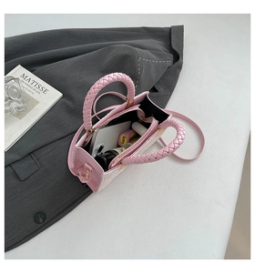 Internal view of pink handbag showing storage capacity for phone and lipstick