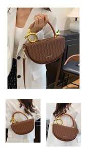 Close-up of brown woven saddle bag with gold metal ring detail and leather handle