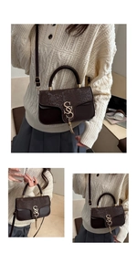 Detail view of dark brown bag featuring snake-print flap and golden S-logo with tassel
