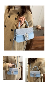 Detail of light blue square handbag with snake pattern flap and gold metal S buckle