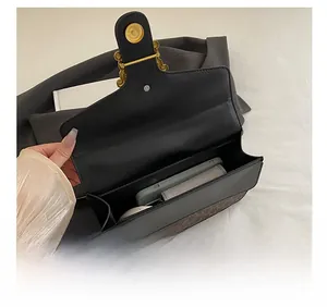 Detail showing internal capacity of vintage faux leather handbag with retro gold buckle