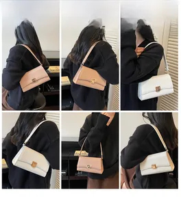 Detail view of retro baguette bag in beige and white with elegant gold metal buckle