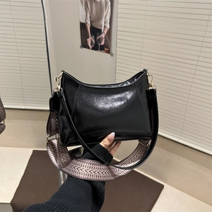 Chic black patent leather crescent shoulder bag with geometric woven strap for women